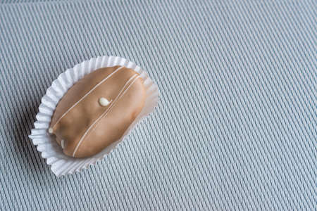 closeup of chocolate eclair on grey background