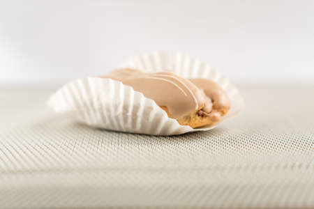 closeup of chocolate eclair on grey background