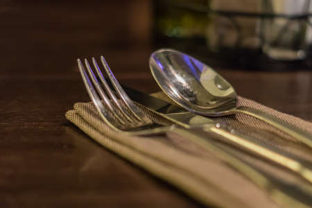 Served fork, spoon and knife on table.の写真素材