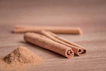 cinnamon sticks and powder on wooden table.の写真素材