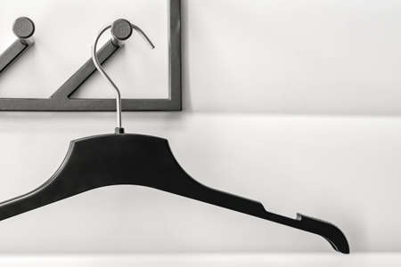 black plastic hanger on white wall backgroundの写真素材