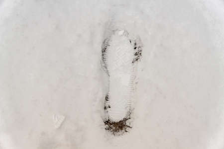 footprint on snow backgroundの写真素材