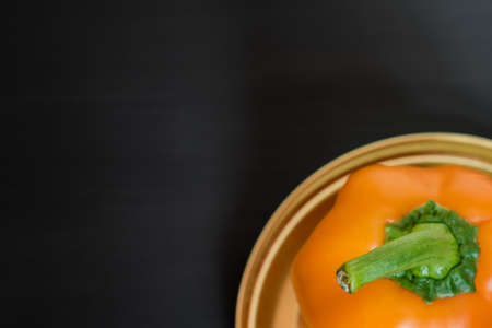 orange bell pepper on black background, top view, copy space for your textの写真素材