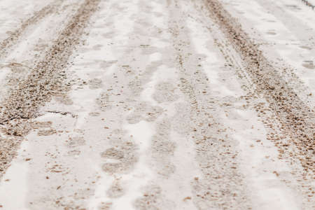 roadway covered with snow and wheels traces