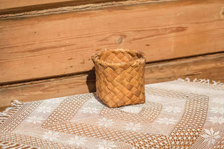 birch bark basket on white openwork tableclothの写真素材