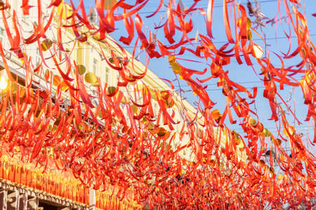 red strips of cloth hanging on a string against blue skyの写真素材