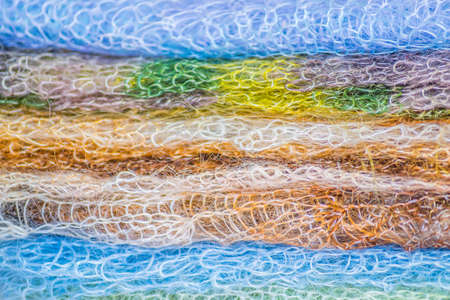 pile of knitted colorful shawls for background