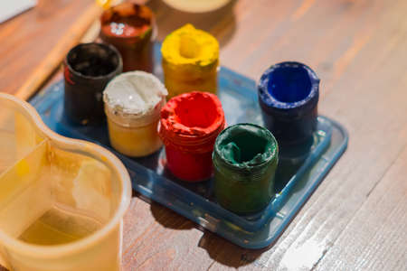 gouache set, pure water, paintbrush. painter workplace ready for drawing.の写真素材