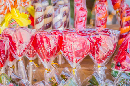 closeup of colorful lollipops n heart shape in a shopの写真素材