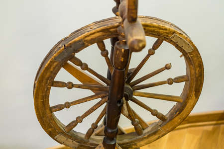 closeup of antique wooden spinning wheelの写真素材