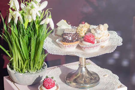 plate with desserts and snowflowers on table