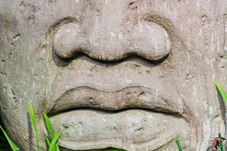 closeup of a Big head statue made of stone
