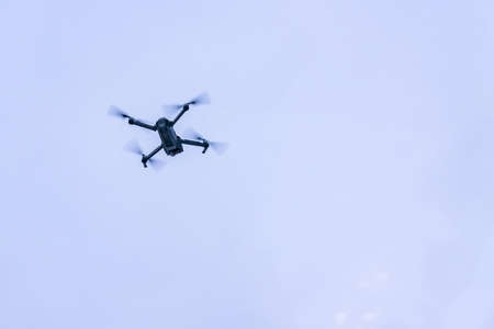 flying drone against blue sky