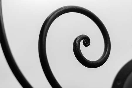 Close up view of iron decorative curved elements on white backgroundの写真素材