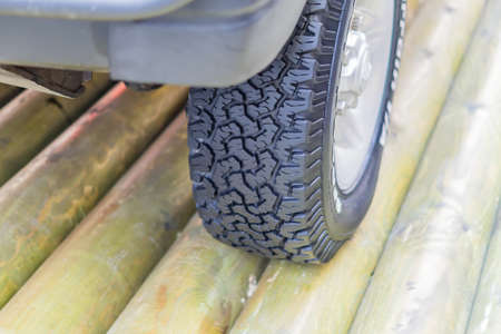 close up of off road tyre on wooden brigeの写真素材