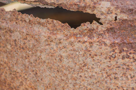Hole in rusty iron background