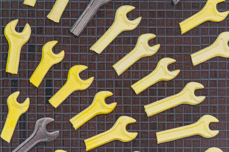 Set of yellow and brown wrenches  hanging on the wall foe decoration