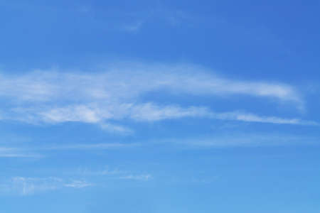 blye sky with white fluffy clouds backgroundの写真素材