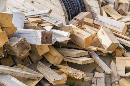 pile of wooden logs and desks outdoors