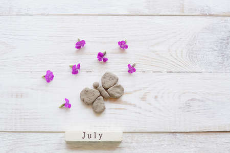 first day of July, colorful background with calendar, flowers and clay butterflyの写真素材
