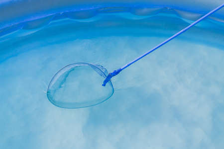 cleaning of Garden Swimming Pool . Skimmer net close upの写真素材