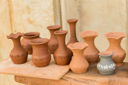 different clay pots on a wooden table
