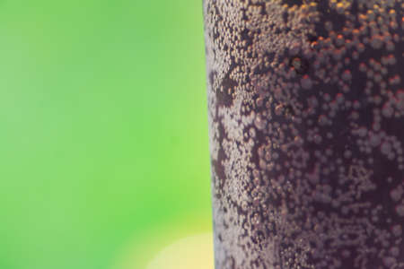 close up of glass of rye kvas on green background. Traditional russian drink with bubblesの写真素材