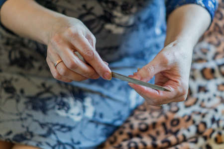woman making manicure to herselfの写真素材
