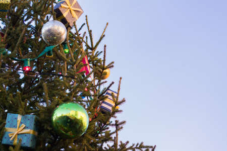 Christmas and New Year holidays background. Christmas tree decorated with balls, gift boxes and...