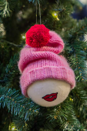 Christmas and New Year holidays background. Christmas tree decorated with toy with knitted red hat. Celebration conceptの写真素材