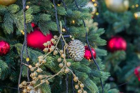 close up of christmas tree decorated with gold small balls. New year background