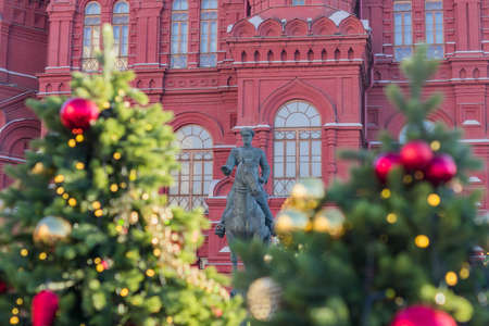 The monument to Marshal Georgy Zhukov and Christmas trees on Historical Museum on Red Square in Moscow, Russiaの写真素材