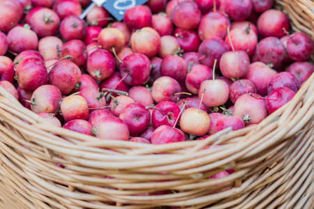 close up of red ripe apples in a basket at the farmer's marketの写真素材
