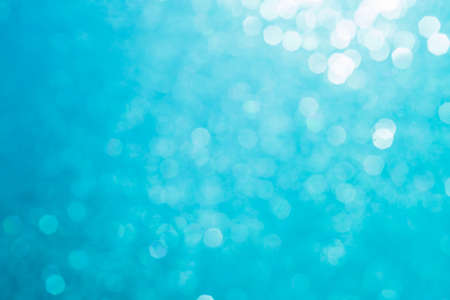 Bokeh abstract texture. Beautiful christmas background in light blue colors. Defocusedの写真素材
