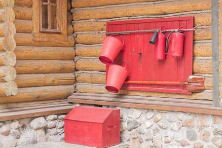 wooden shield with fire fighting tools on the wall of the house, close upの写真素材
