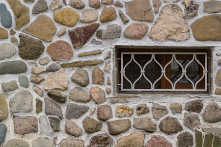 old stone wall and white lattice on a window.の写真素材