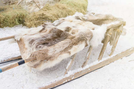 close up of a wooden deer sledge covered with fur lining