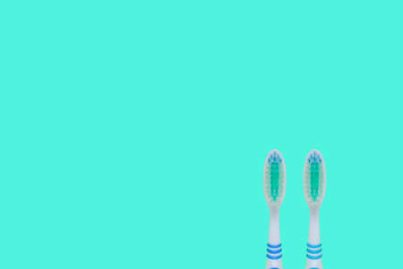 Two toothbrushes on blue background. Top view, minimal flat lay.の写真素材
