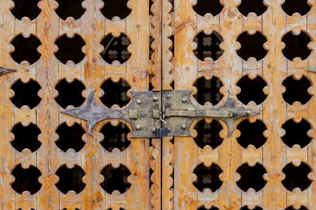 close up locked carved wooden gate