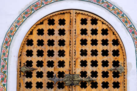 Closed carved wooden gate in rustic style. Close up.の写真素材