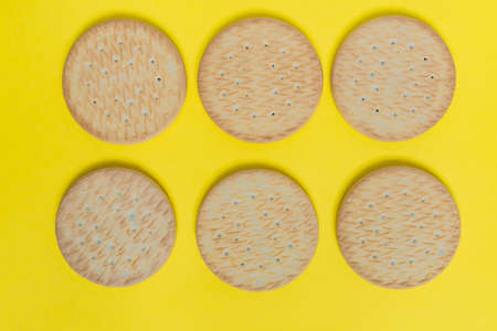tasty round cookies on yellow backgroud top view