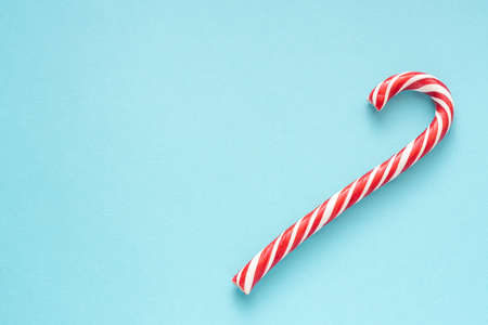 Merry Christmas and Happy New Year greeting card. Two candy canes on blue background with copy space for your text.の写真素材