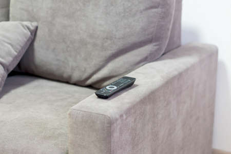 TV remote contoller lying on the coach