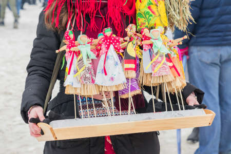 Small Shrovetide dolls on street fair - scarecrow for burning as symbol of spring coming.の写真素材