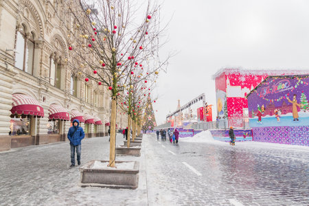 Moscow, Russia - December 20: Christmas decorations on Red Square in Moscow on background of St. Basil's Cathedral. Winter holiday postcard from Red Square under snowfall.のeditorial素材
