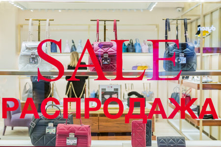 Moscow, Rusiia - December 20, 2018: Furla shop window with SALE inscription in English and Russian. Retail shop in GUM shopping mallのeditorial素材