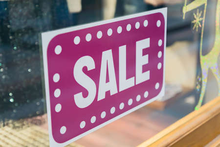 Sale sticker on wondow shop. Season discount shopping.の写真素材