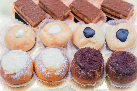 Pastry shop display window with variety of mini desserts and cakes, selective focus