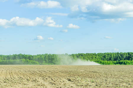 rural landscape in summer sunny day. Agricultural works in the fieldの写真素材