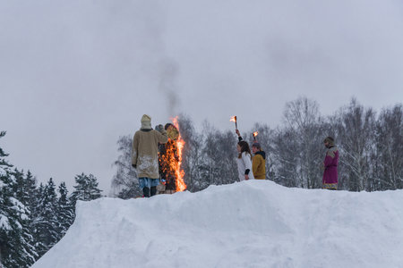 Moscow Region, Russia - February 18, 2018: Celebration of Russian Shrovetide. Burning of scarecrow for the honor of winter end.のeditorial素材